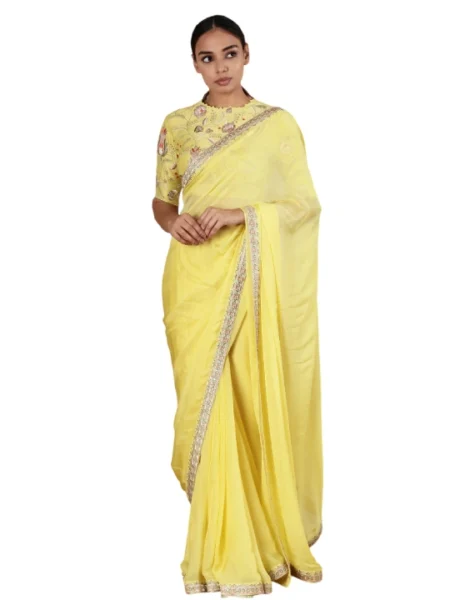 Yellow floral thread work blouse with sequin detail. Paired with embroidered hem saree.