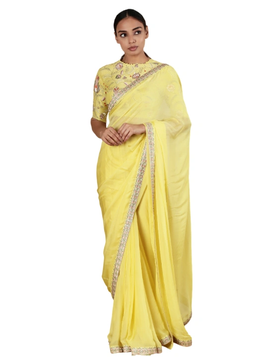 Yellow floral thread work blouse with sequin detail. Paired with embroidered hem saree.